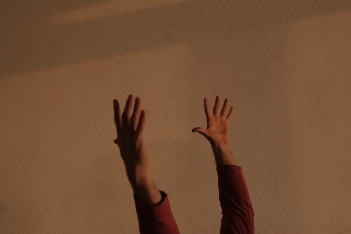 Two pairs of hands meeting in movement
